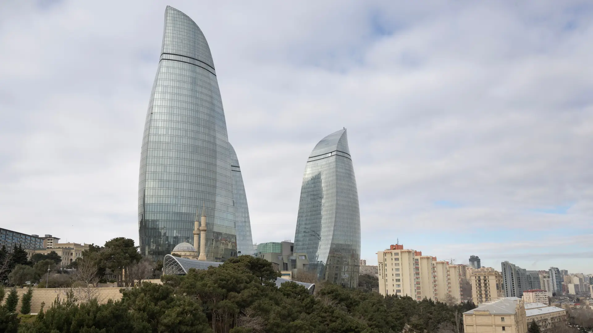Stunning view of Baku's Flame Towers with surrounding urban park and cityscape