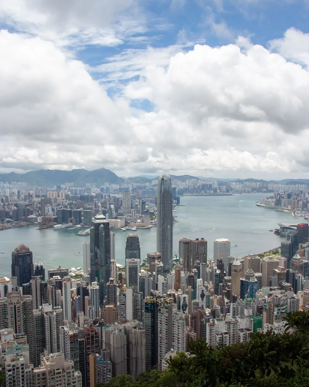 Stunning aerial view of Hong Kong's skyline with Victoria Harbour under a dramatic sky