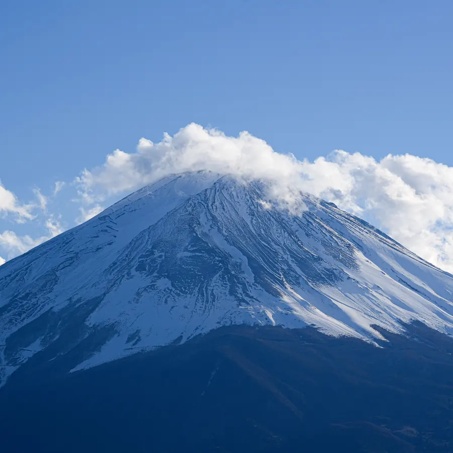 Serene view of snow-capped Mount Fuji under clear blue skies, perfect for nature lovers
