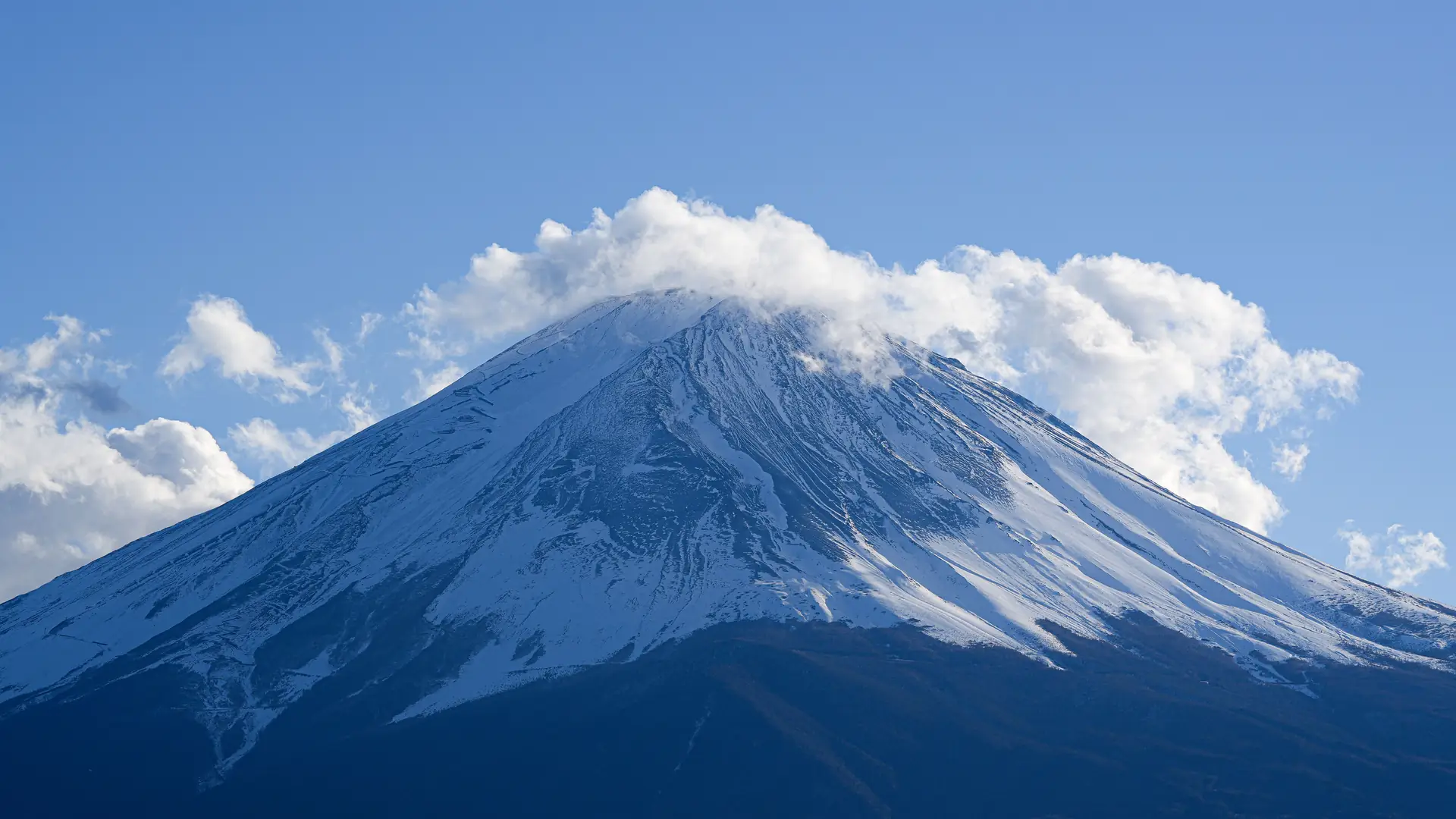 Serene view of snow-capped Mount Fuji under clear blue skies, perfect for nature lovers