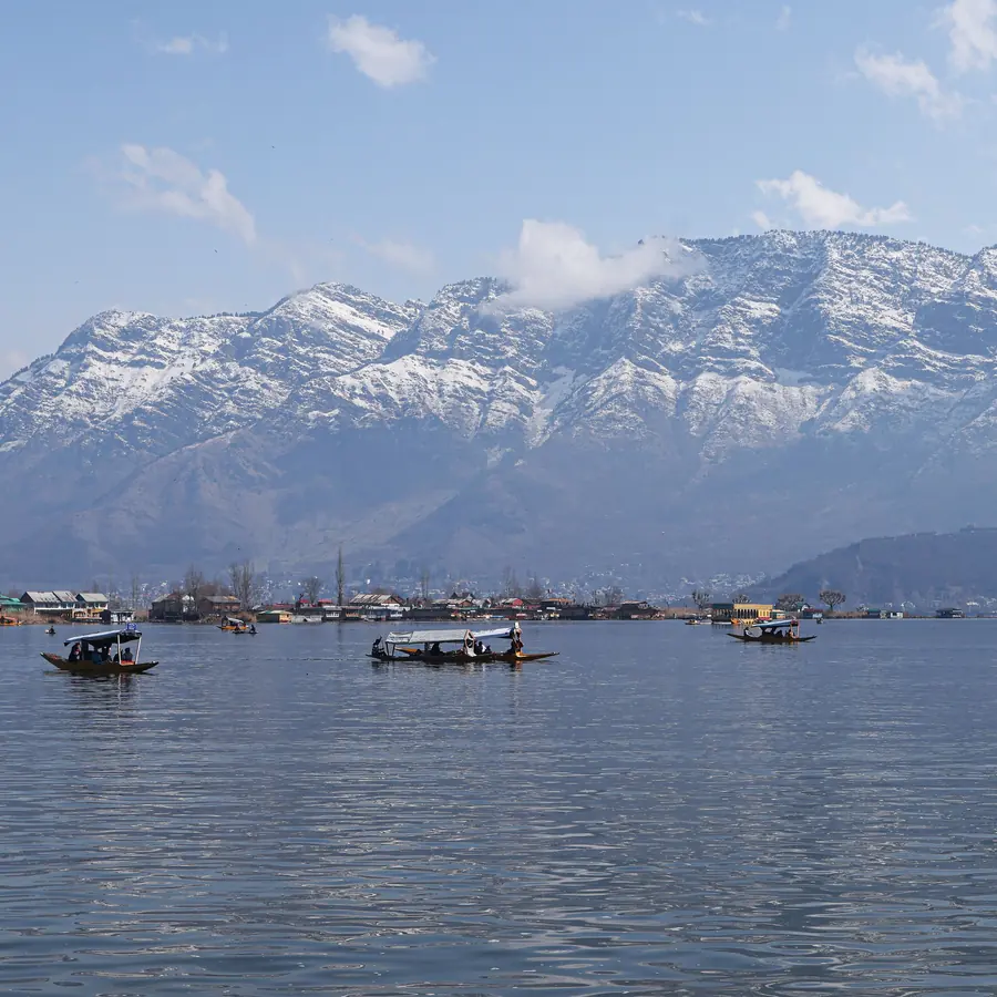 Shikaras on Dal Lake with the majestic Himalayas in the background
