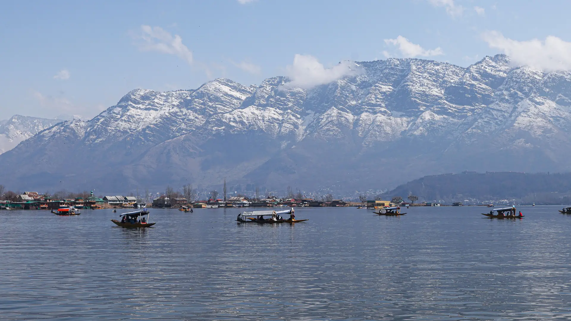 Shikaras on Dal Lake with the majestic Himalayas in the background