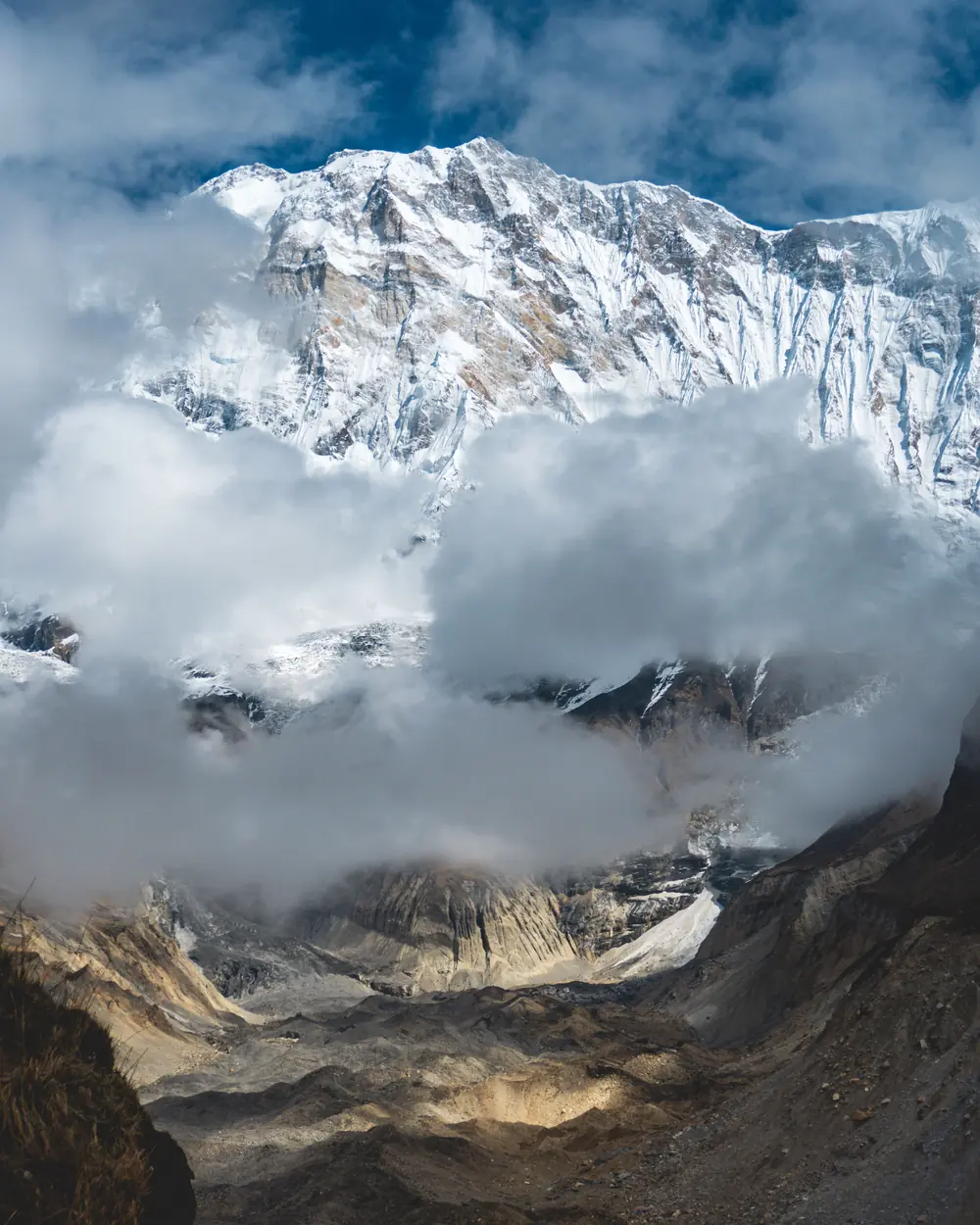 Stunning view of snow-capped Annapurna peaks with dramatic clouds in Nepal's Himalayas