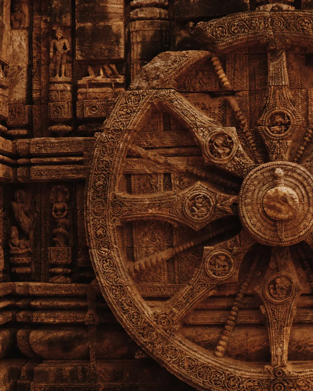 Close-up of the intricately carved stone wheel at Konark Sun Temple, showcasing ancient craftsmanship