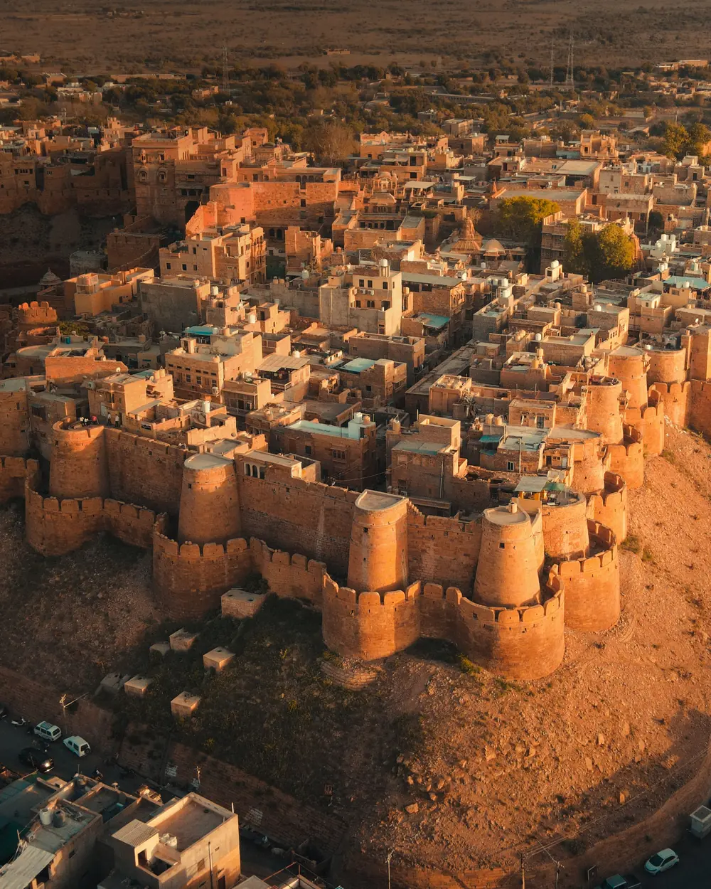 Breathtaking aerial view of the historic Jaisalmer Fort in Rajasthan, India at sunset. A golden monument in the Thar Desert