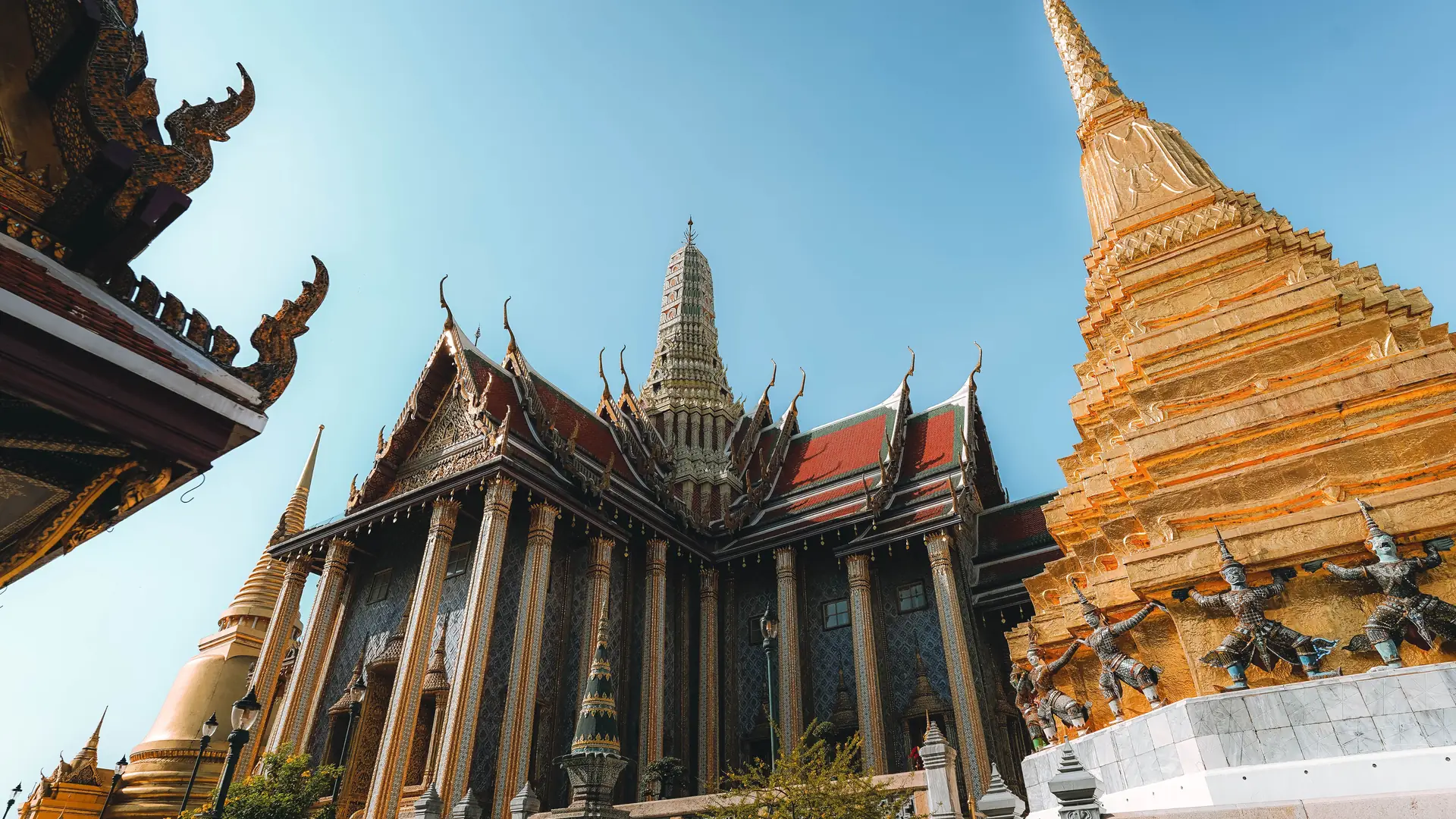 Beautiful capture of Grand Palace temple's intricate architecture and golden pagoda in Bangkok, Thailand